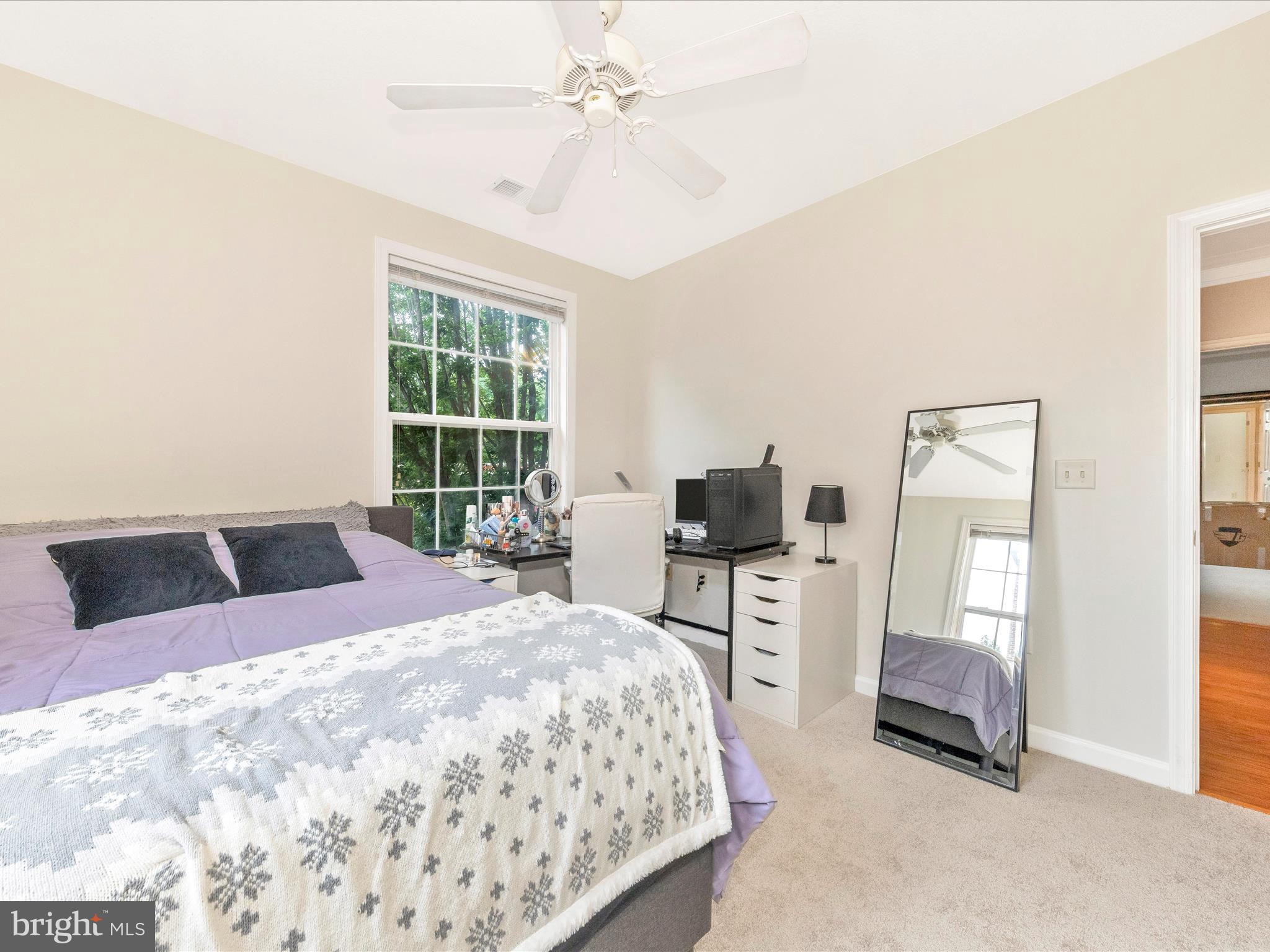 7 Booth Street, Unit 201 Gaithersburg, MD 20878 - Photo 24 of 67 a bedroom with a bed and wooden floor