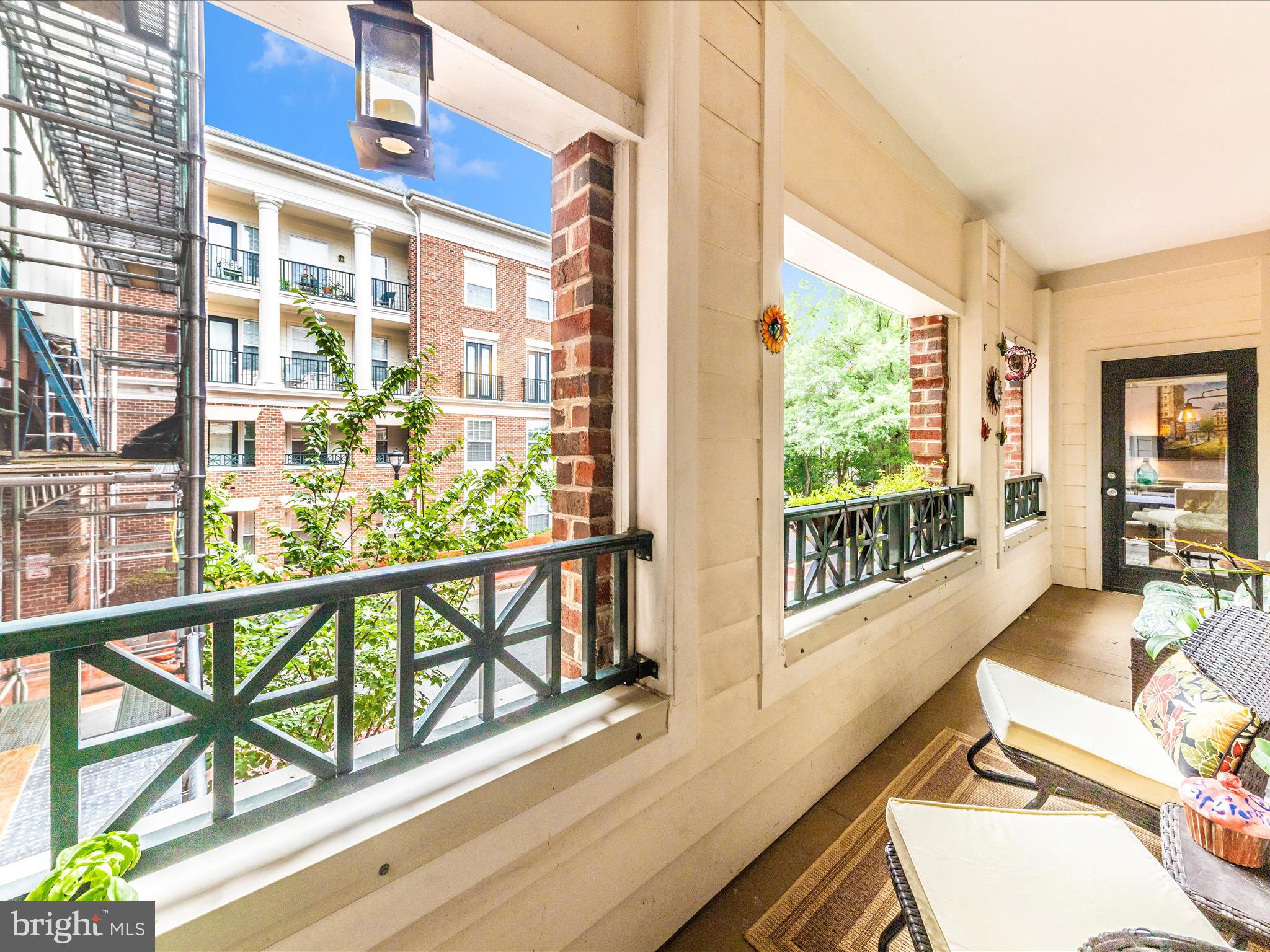 7 Booth Street, Unit 201 Gaithersburg, MD 20878 - Photo 30 of 67 a view of a balcony with floor to ceiling windows with wooden floor