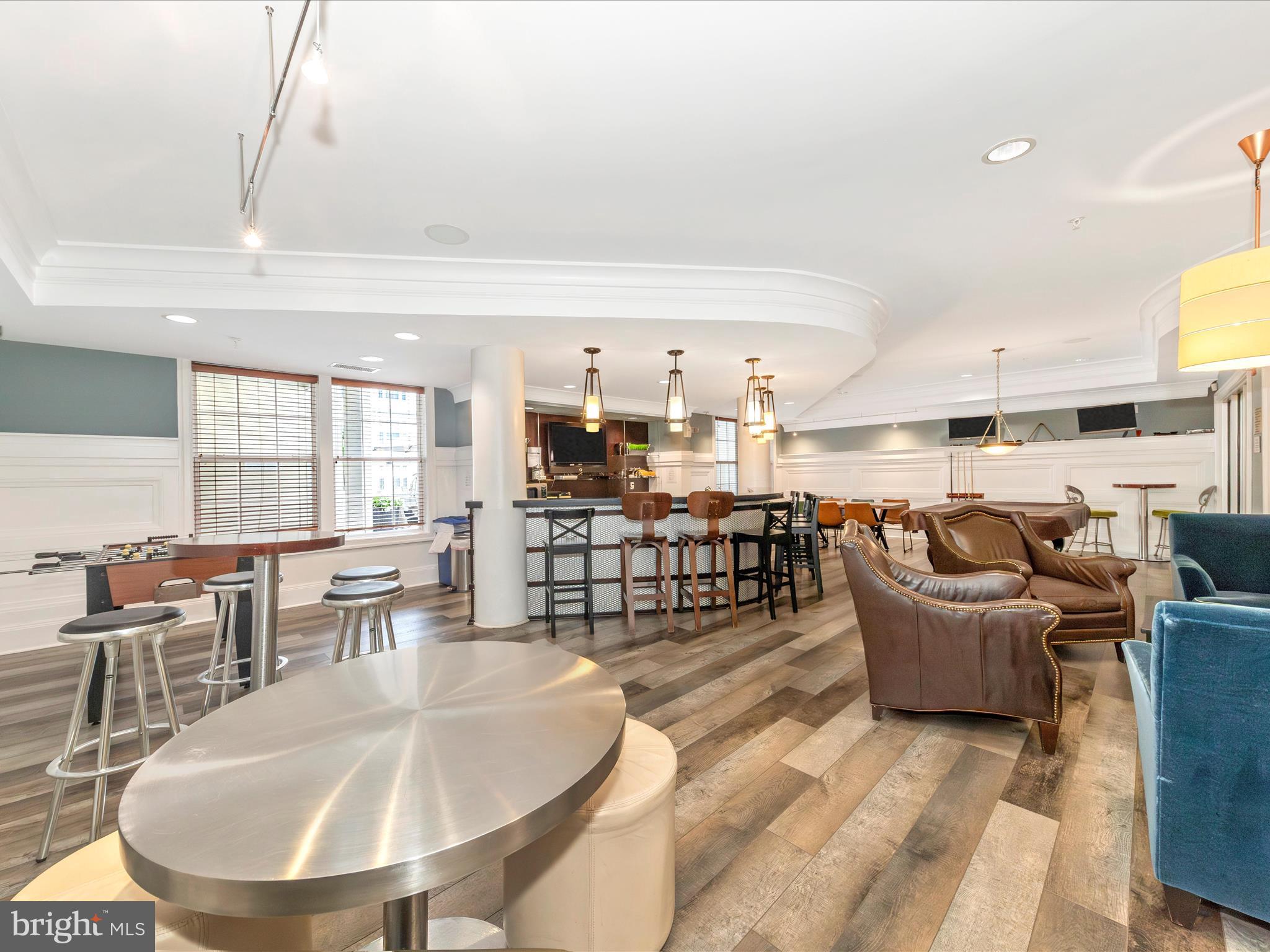 7 Booth Street, Unit 201 Gaithersburg, MD 20878 - Photo 39 of 67 a living room with lots of chairs and a dining table with kitchen view
