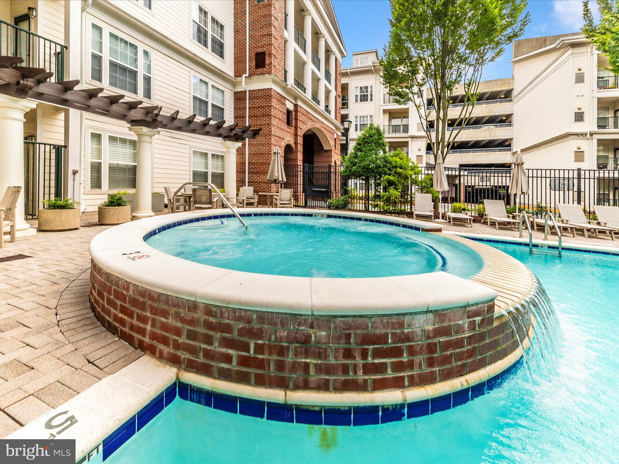 7 Booth Street, Unit 201 Gaithersburg, MD 20878 - Photo 46 of 67 a view of a house with a swimming pool and sitting area