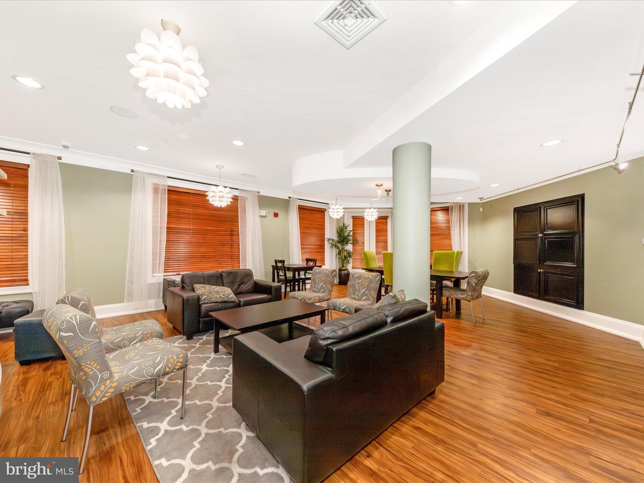 7 Booth Street, Unit 201 Gaithersburg, MD 20878 - Photo 49 of 67 a living room with furniture and a flat screen tv