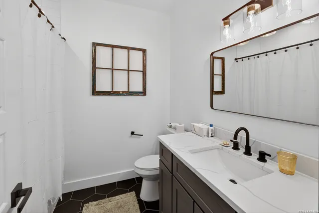 a bedroom with a bed a window and a chandelier