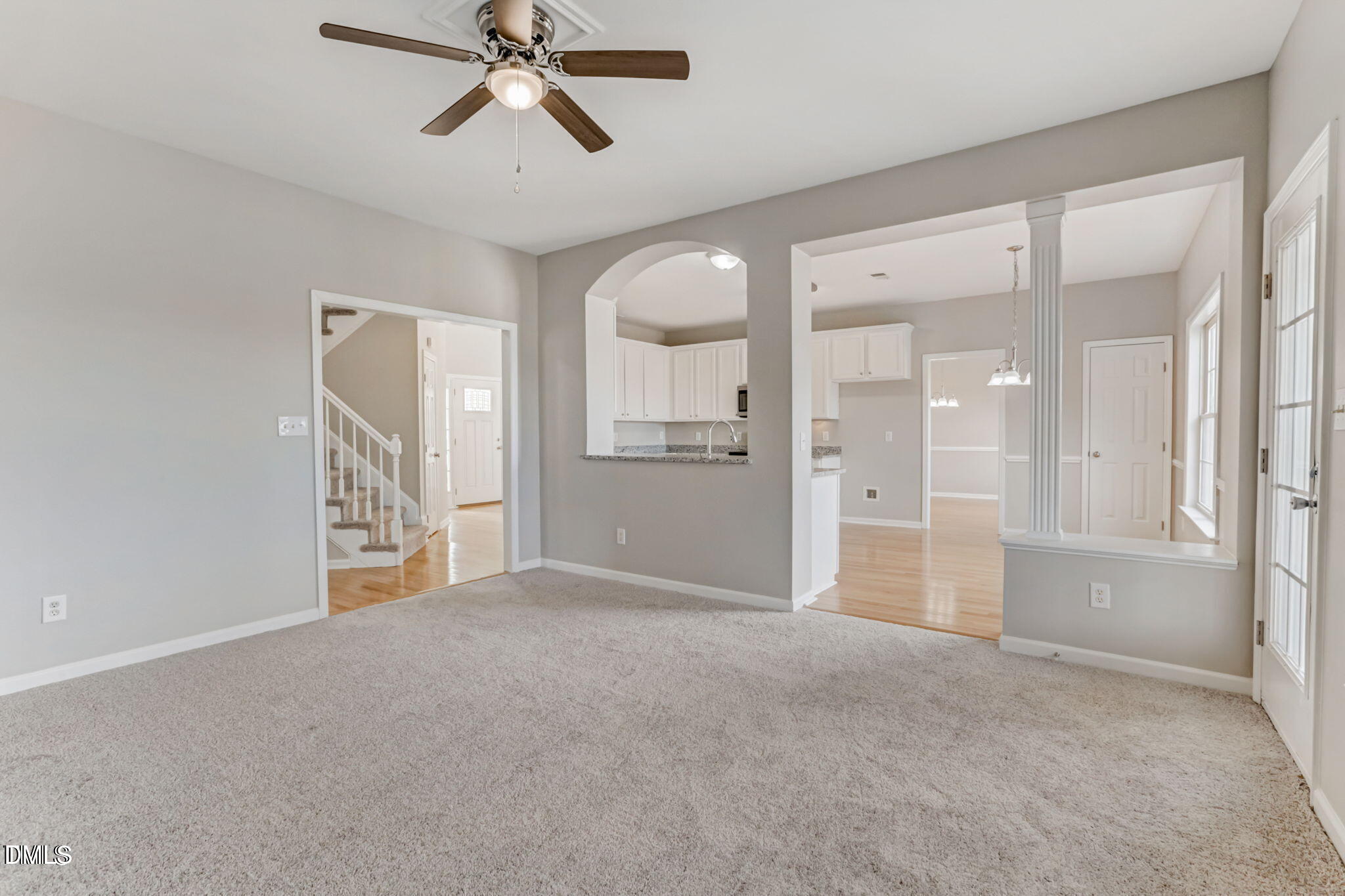 480 Seastone Street Raleigh, NC 27603 - Photo 12 of 26 a view of a big room with a chandelier fan and windows