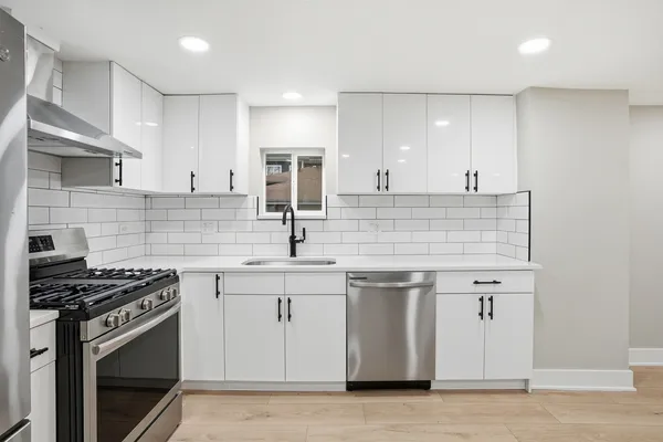 a bathroom with a shower sink mirror and toilet