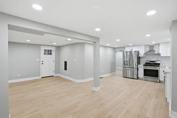 a view of a kitchen with a sink and a refrigerator