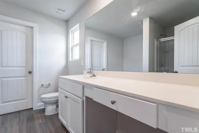 a view of bathroom with a sink toilet and a mirror