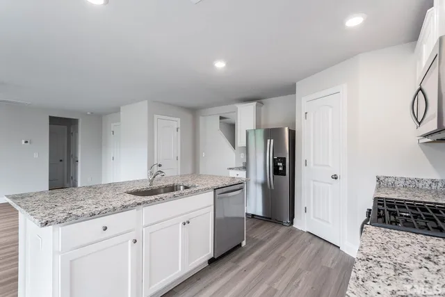 a kitchen with a sink stove and refrigerator
