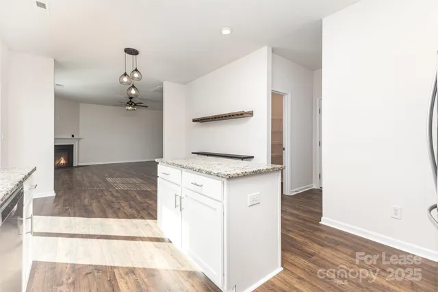 a kitchen with granite countertop a stove and a sink