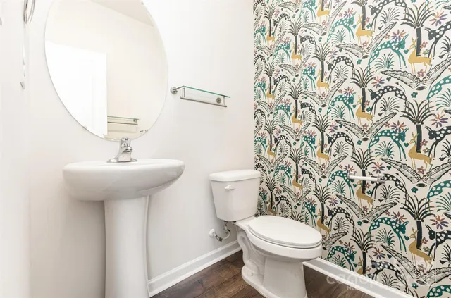 a bathroom with a sink a toilet and a mirror