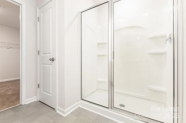 a bathroom with a glass shower door