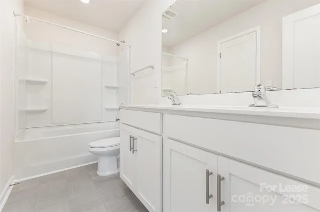 a bathroom with a toilet a sink a tub and mirror