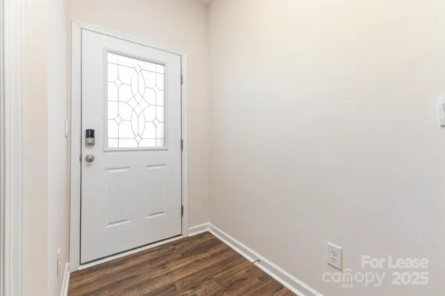 a view of an empty room and wooden floor