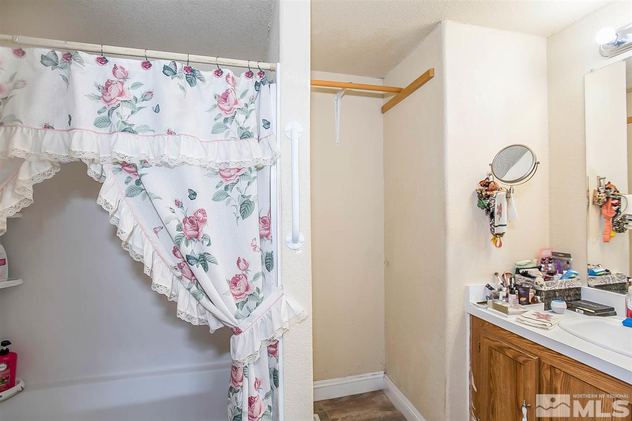 2735 Snapdragon Way Reno, NV 89512 - Photo 11 of 18 a bathroom with a sink mirror and vanity