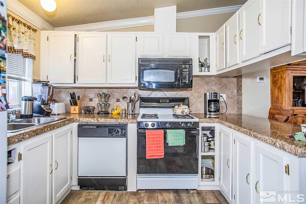 2735 Snapdragon Way Reno, NV 89512 - Photo 3 of 18 a kitchen with stainless steel appliances granite countertop a refrigerator and a stove top oven