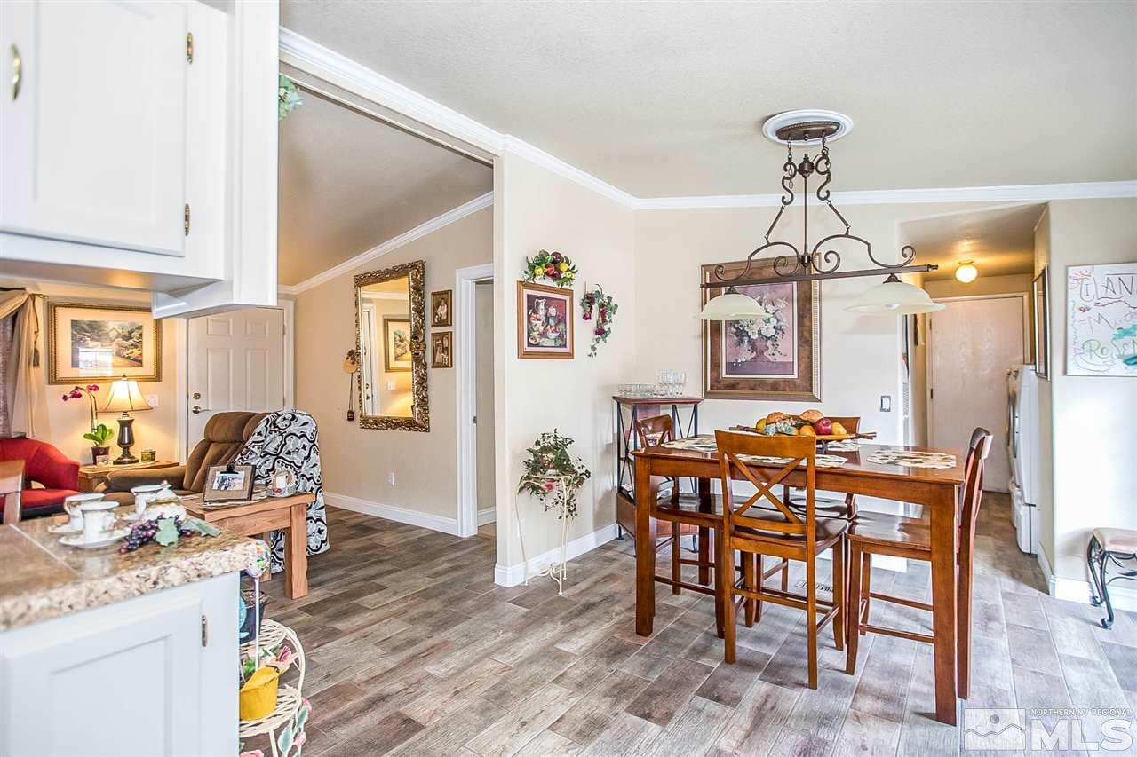 2735 Snapdragon Way Reno, NV 89512 - Photo 5 of 18 a view of a dining room and livingroom with furniture wooden floor a chandelier