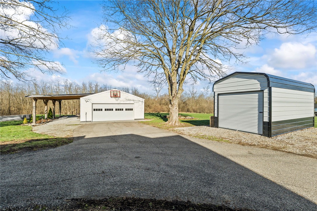 10797 Gratis Jacksonburg Road Somerville, OH 45064 - Photo 4 of 27 This property offers generous garage and storage space, perfect for vehicles and outdoor equipment.