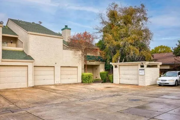 a view of a parking space in front of a house