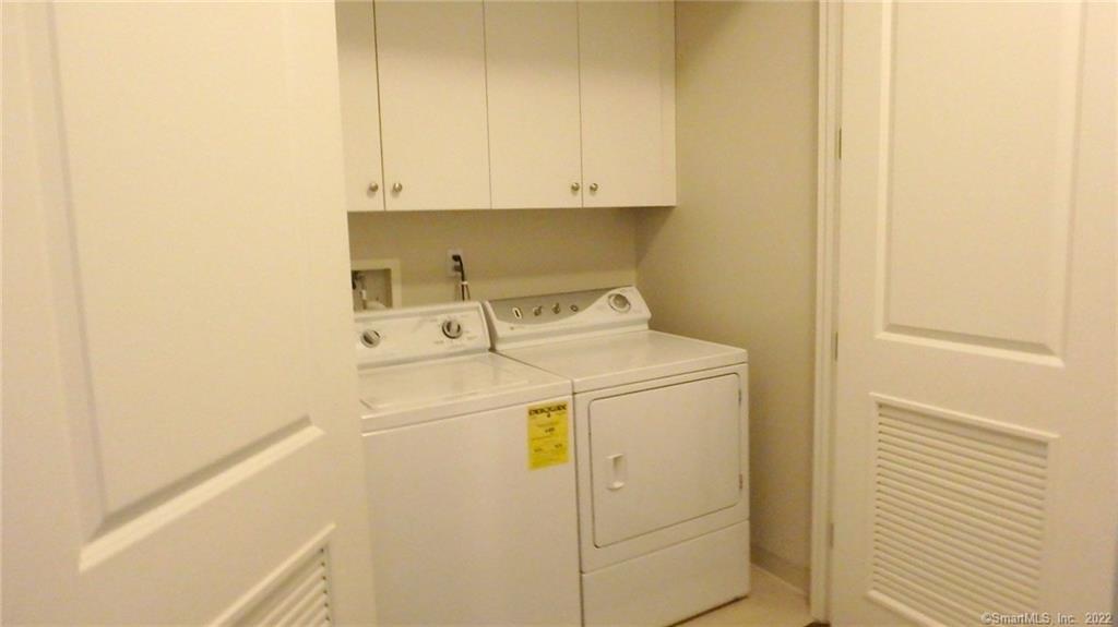 75 Stone Ridge Way, Unit 3E Fairfield, CT 06824 - Photo 13 of 23 Enclosed in hallway is full size washer and dryer with plenty of storage above