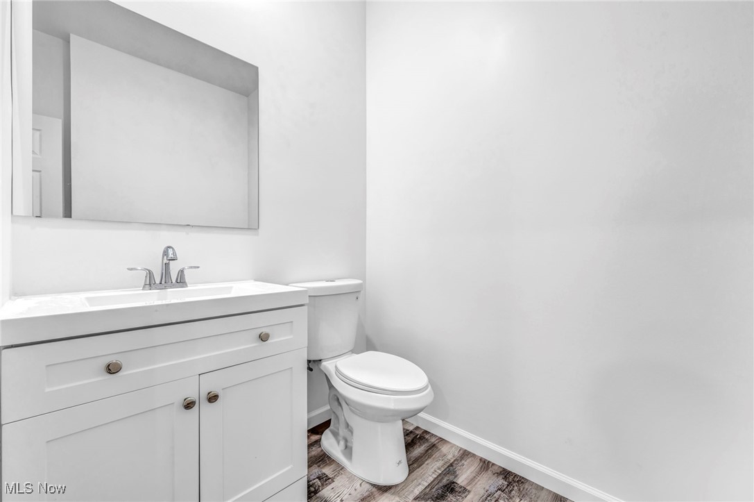 3709 Sudbury Road Cleveland, OH 44120 - Photo 13 of 29 Bathroom with hardwood / wood-style floors, toilet, and vanity