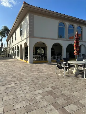 a couple of table and chairs in front of white building