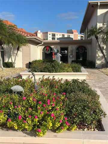a view of a house with a yard and garden