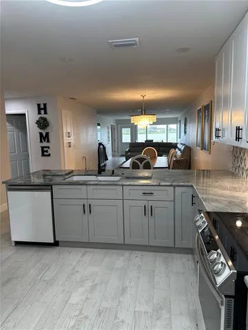 a kitchen with sink and cabinets