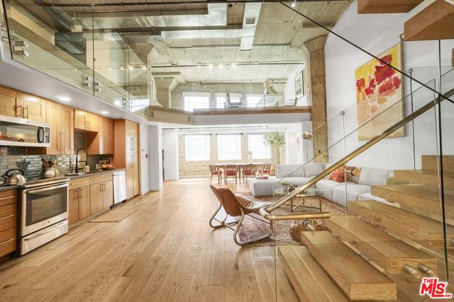 a living room with furniture kitchen view and a kitchen