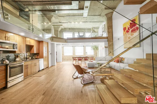 a living room with furniture kitchen view and a kitchen