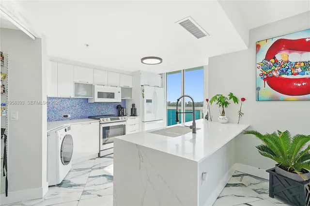 a bedroom with a bed and a view of kitchen