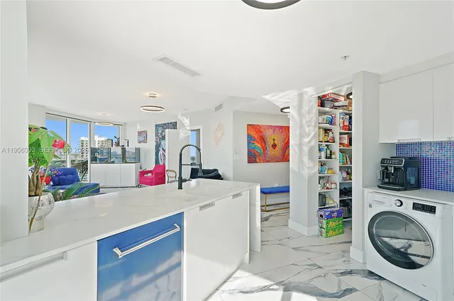 a dining room with furniture and floor to ceiling window