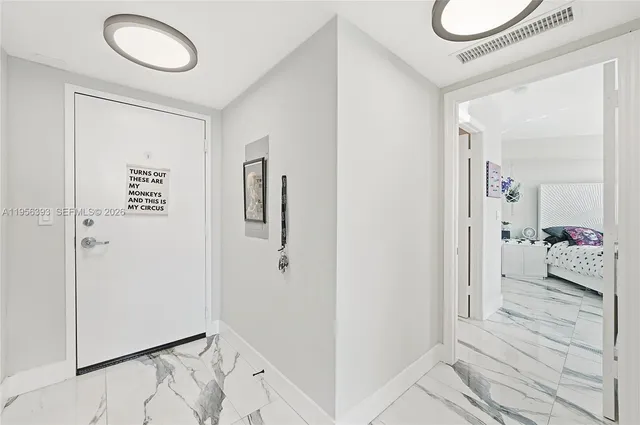 a view of a livingroom with furniture and large windows