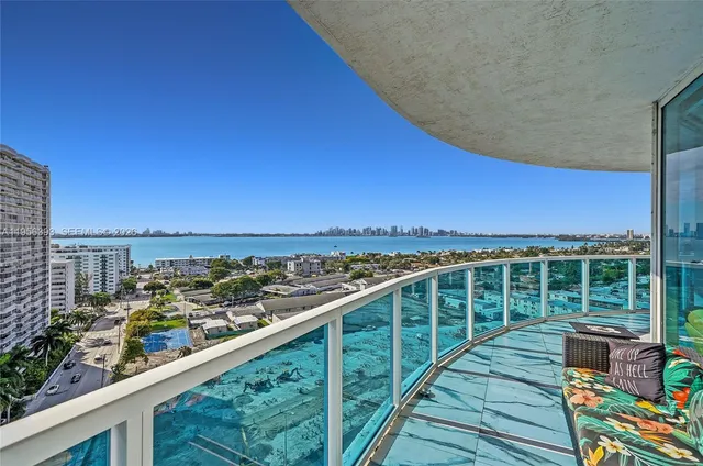 a view of a lake with a building and wooden floor