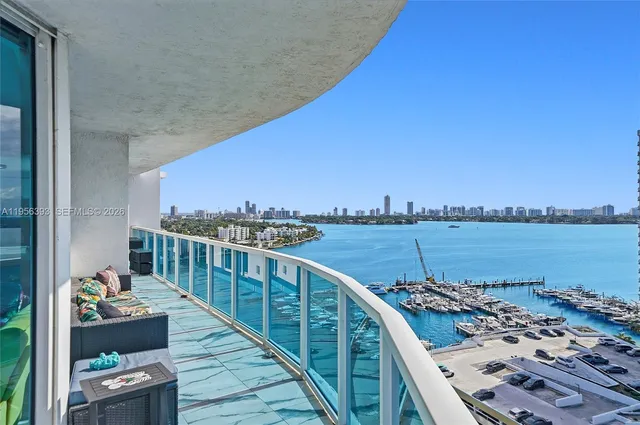 a view of a lake with boats and trees in the background