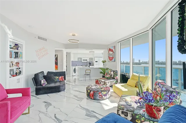 a living room with furniture and a floor to ceiling window