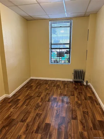 a view of a room with wooden floor and bench