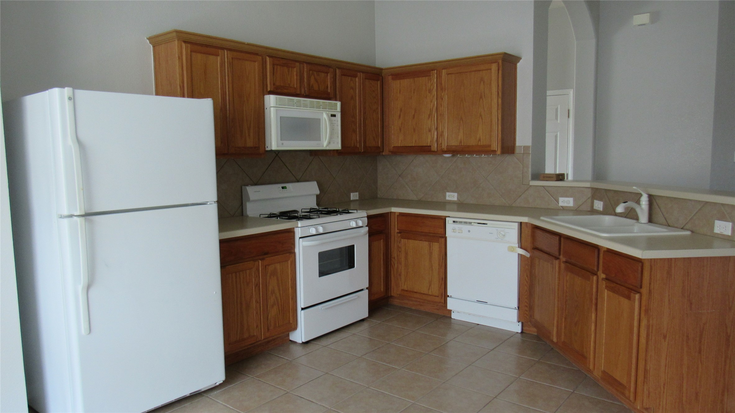 1510 Ridgewood Drive Leander, TX 78641 - Photo 2 of 19 a kitchen with a white stove top oven and refrigerator