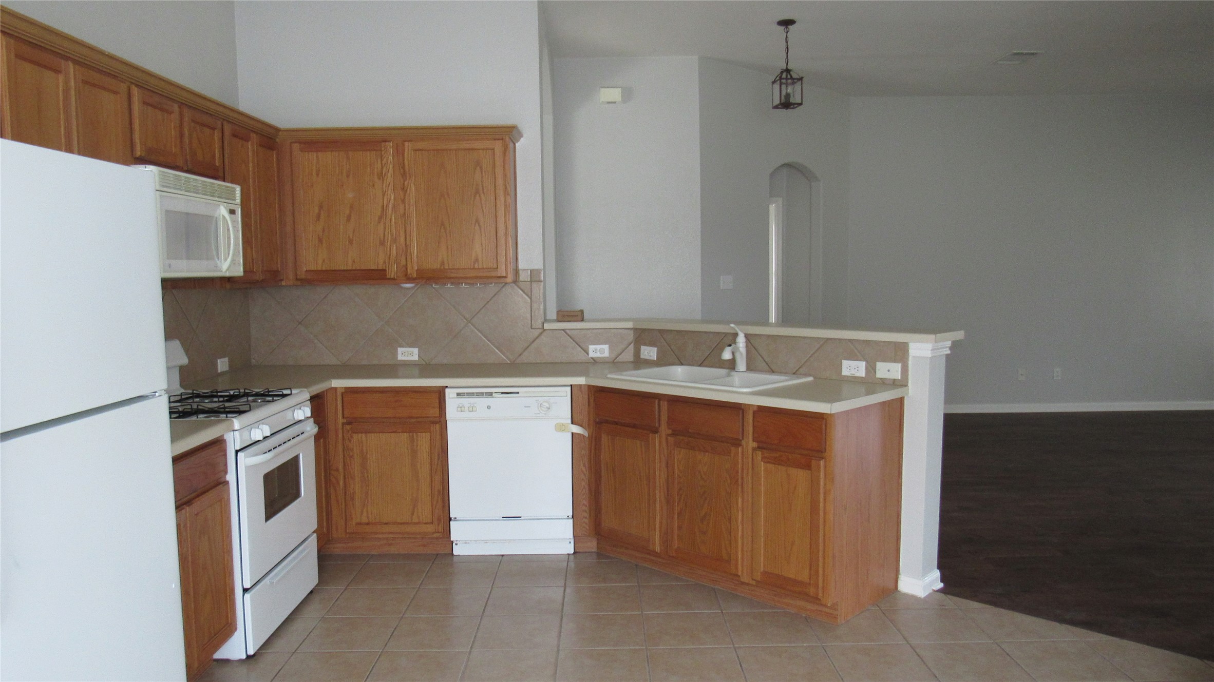 1510 Ridgewood Drive Leander, TX 78641 - Photo 3 of 19 a kitchen with stainless steel appliances granite countertop a sink stove and refrigerator