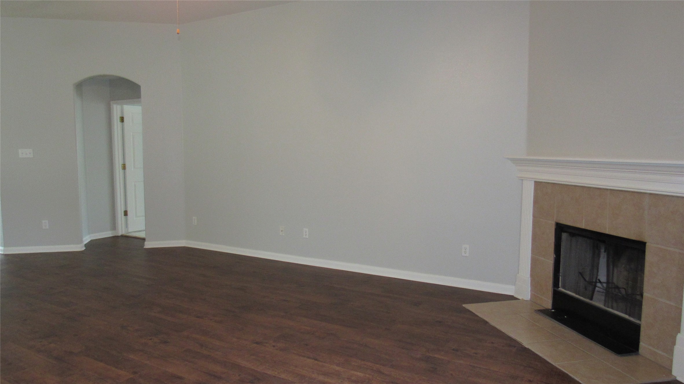 1510 Ridgewood Drive Leander, TX 78641 - Photo 8 of 19 a view of an empty room with wooden floor and a fireplace