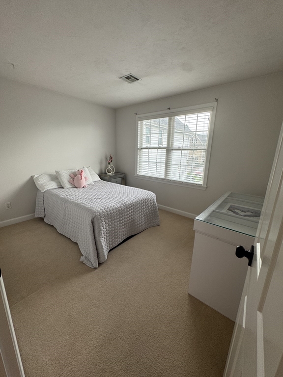 45 Crescent Road, Unit 45 Needham, MA 02494 - Photo 16 of 25 a bedroom with a bed and a window