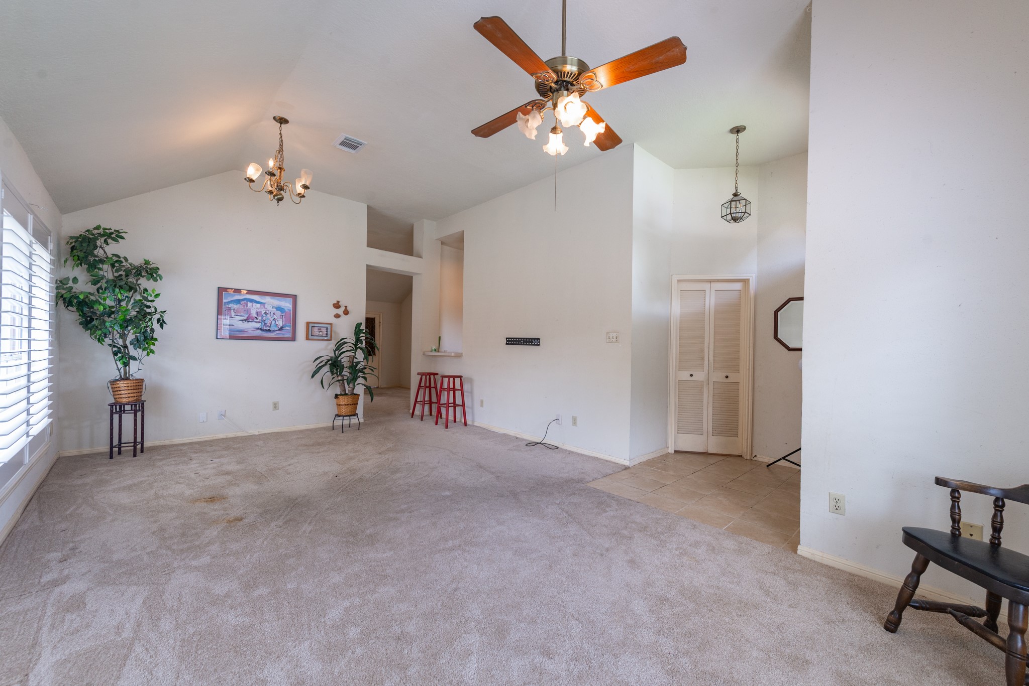 12203 Canterhurst Way Houston, TX 77065 - Photo 4 of 23 en empty room with windows and ceiling fan
