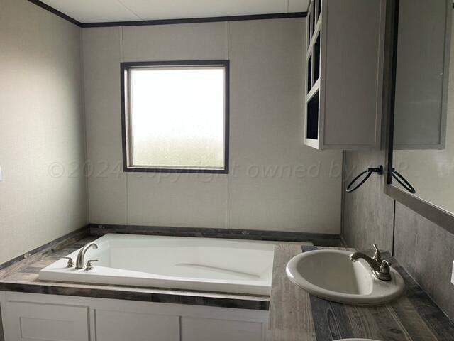 4100 Raef Road Amarillo, TX 79108 - Photo 9 of 16 a bathroom with a sink and a mirror