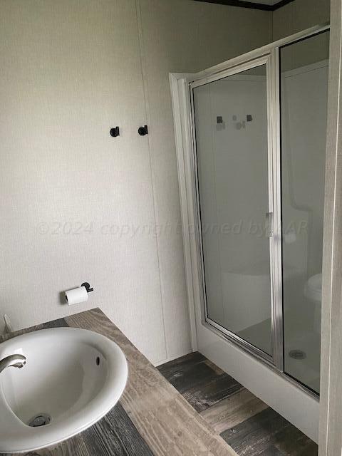 4100 Raef Road Amarillo, TX 79108 - Photo 10 of 16 a bathroom with a sink and shower