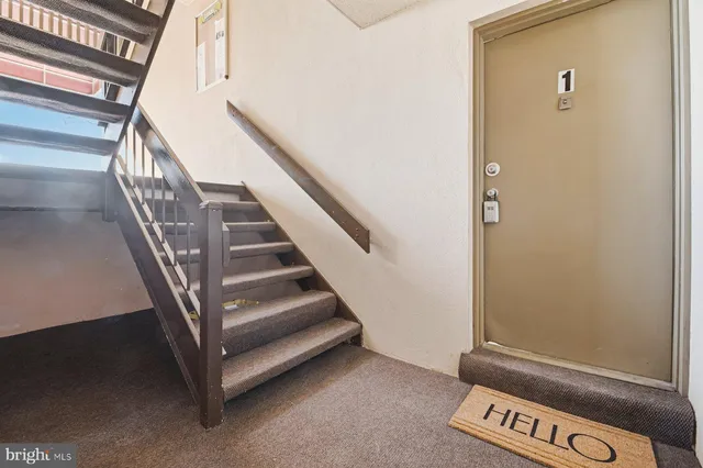 a view of staircase with white walls and a window