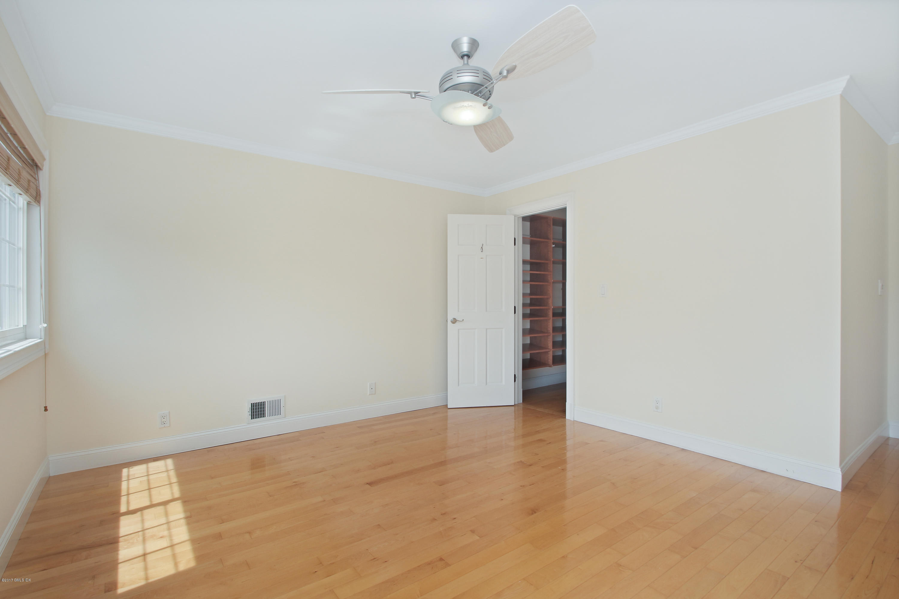 24 Decatur Street, Unit 2 Cos Cob, CT 06807 - Photo 14 of 19 an empty room with an entryway and fan