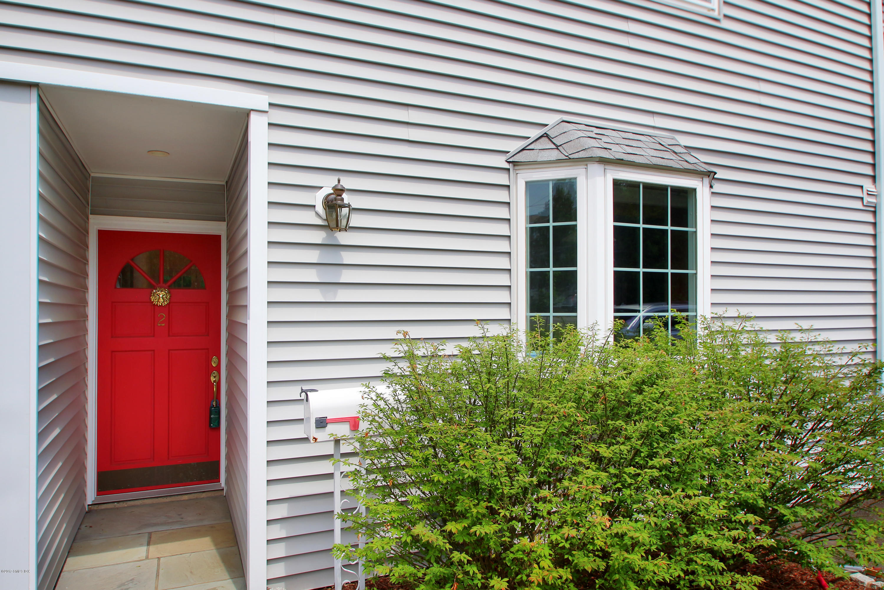 24 Decatur Street, Unit 2 Cos Cob, CT 06807 - Photo 2 of 19 a potted plant sitting in front of a house