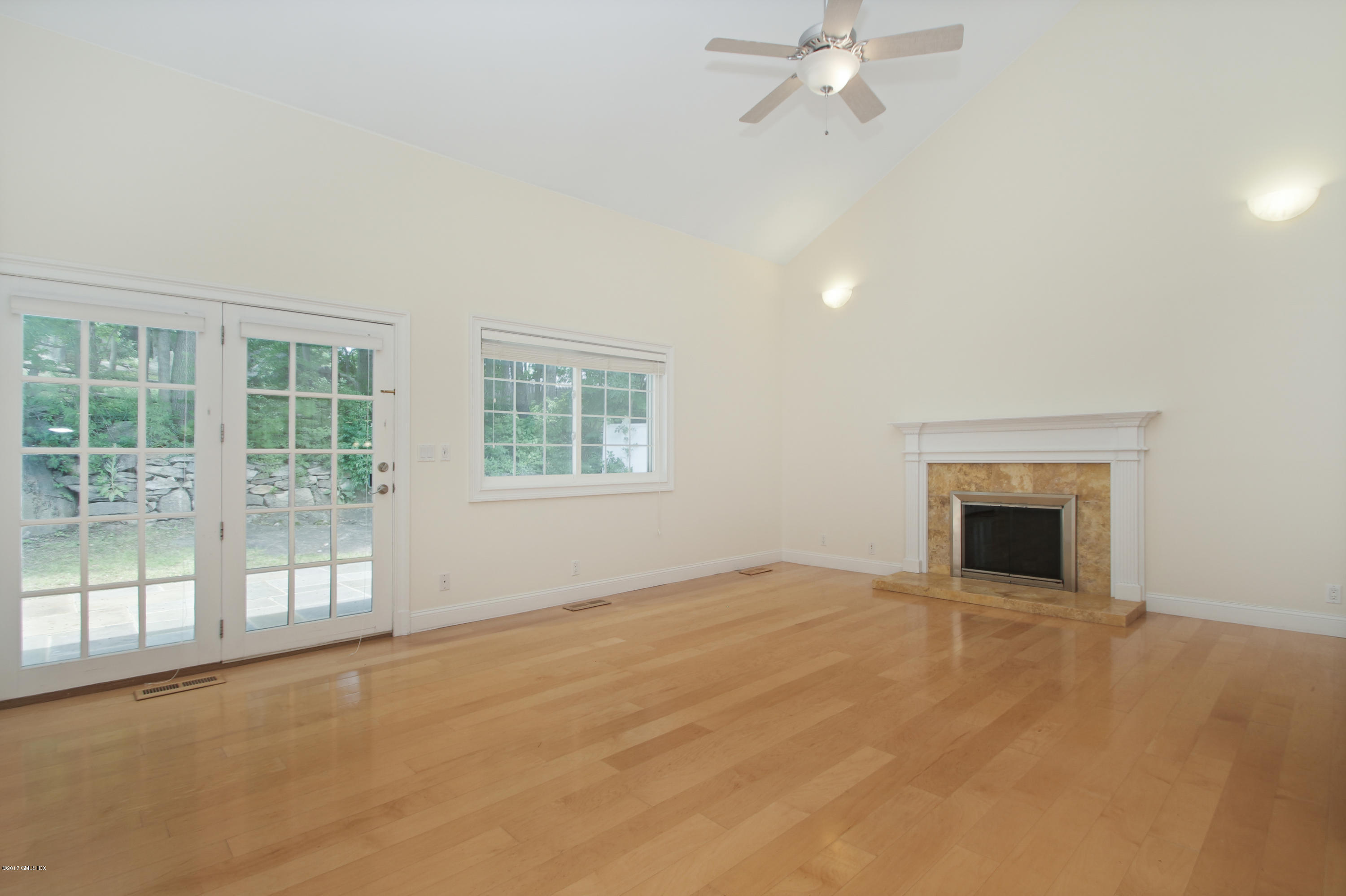 24 Decatur Street, Unit 2 Cos Cob, CT 06807 - Photo 4 of 19 an empty room with windows and fireplace