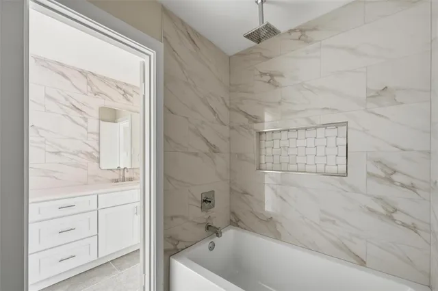 a bathroom with a bathtub and a shower