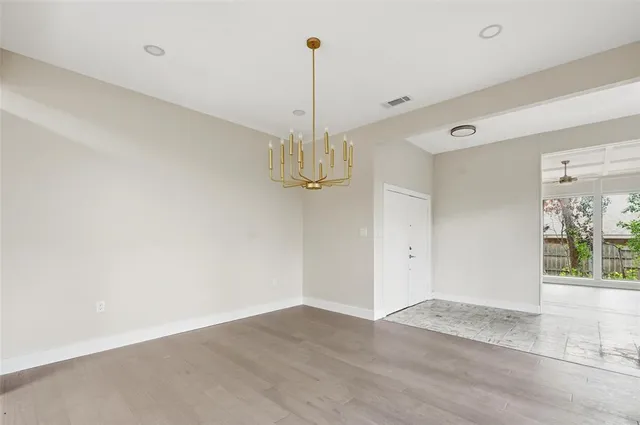 a view of a room with wooden floor and window