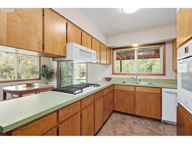 a kitchen that has a sink and a stove in it