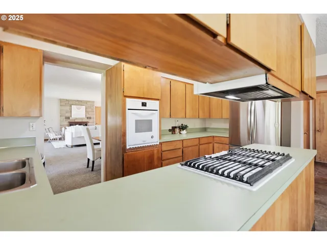 a kitchen that has a lot of cabinets a sink and a stove in it